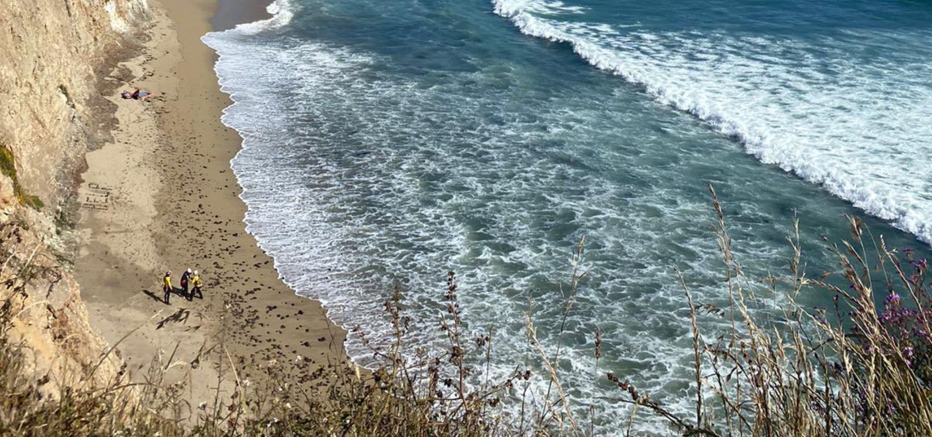 Kite surfer rescued on California beach after writing message in the sand