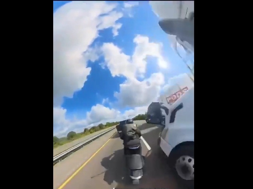 [EXPLICIT VIDEO] Motorcyclist crashes into a car and is run over by a tractor-trailer